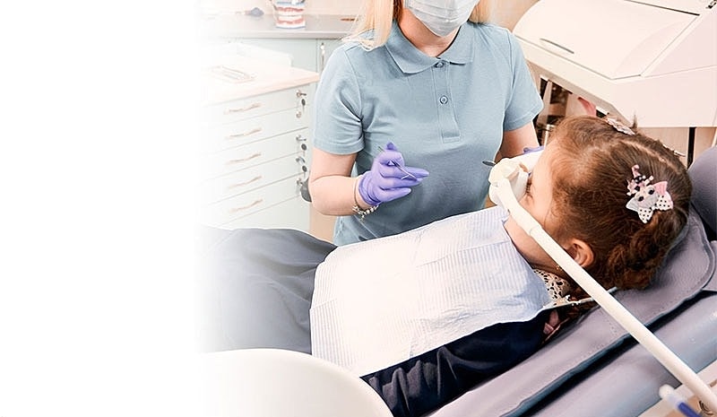 Child receiving dental care from a professional.